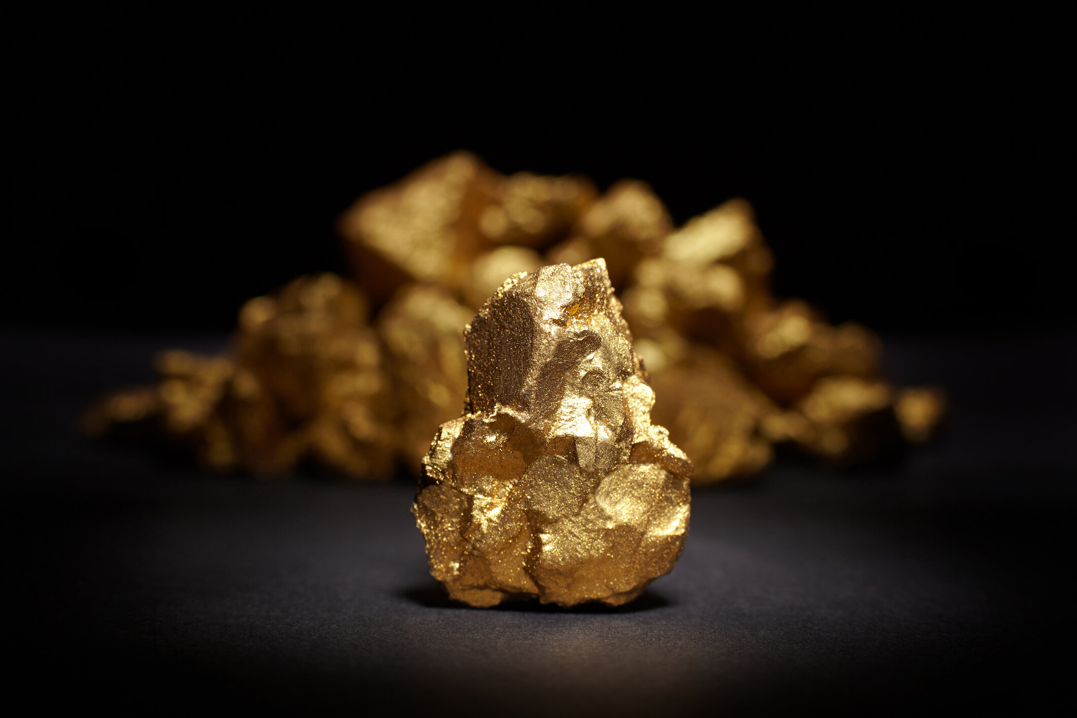 Closeup of big gold nugget on a black background